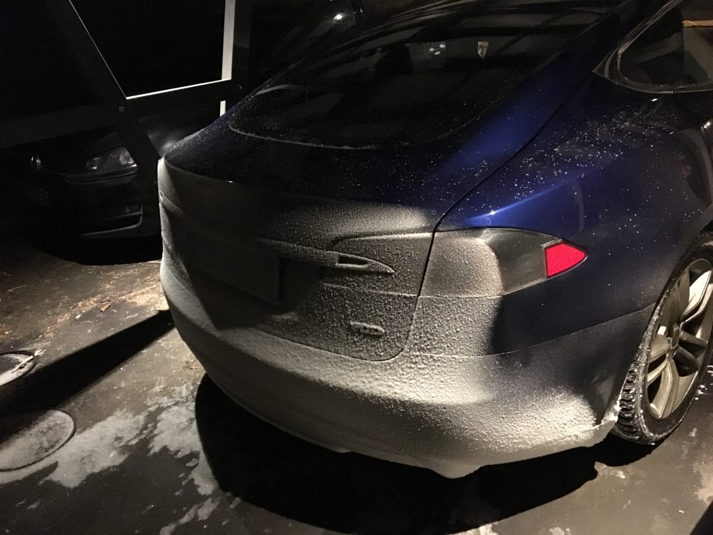 Snow collects on the back of the Model S