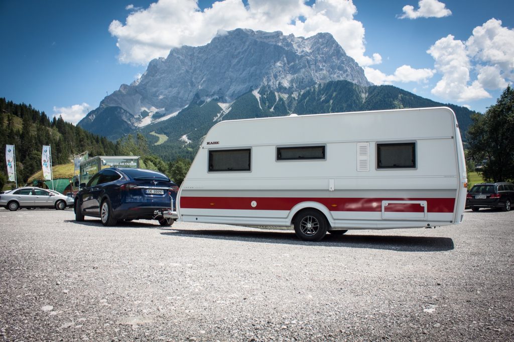 Tesla Model X with caravan trailer in the Alps