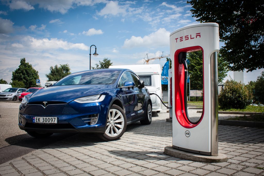 Tesla Model X charging with caravan